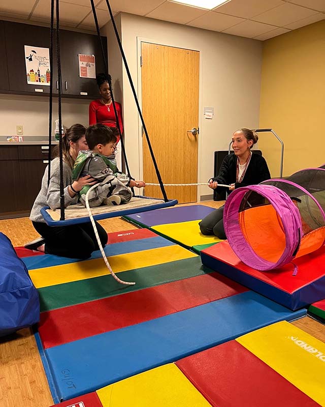 LKC Client on a swing holding a rope